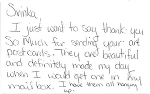 Handwritten note thanking Svinka for the beautiful art postcards, all hung up at home